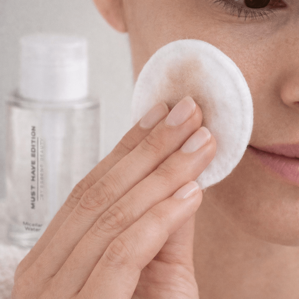 Aplicación de agua micelar hidratante ESSENS sobre algodón para limpiar y desmaquillar el rostro sin irritar la piel.
